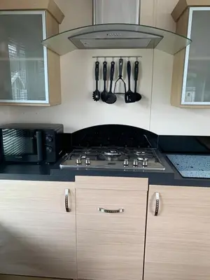 a kitchen with a stove and utensils at Lakeside Lodge Valencia 2 bedroom in Weeley