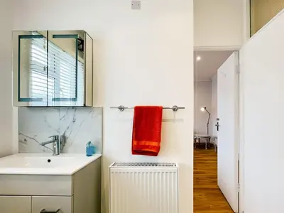 a bathroom with a sink and a red towel at Sea Leigh in Leigh-on-Sea