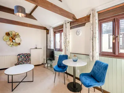 a room with two tables and chairs and a tv at Robin - Uk48171 in Colchester