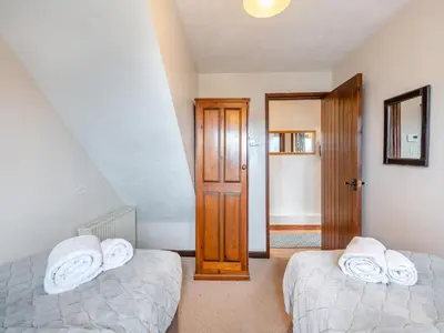 a bedroom with two beds with white towels at Plover - Uk48174 in Colchester