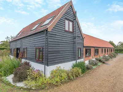 a black and white house with a red roof at Plover - Uk48174 in Colchester