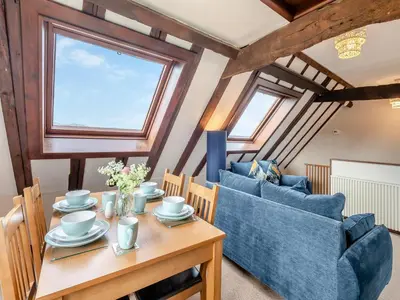 a living room with a table and two couches at Plover - Uk48174 in Colchester