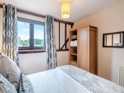 a bedroom with a bed and a window at Plover - Uk48174 in Colchester