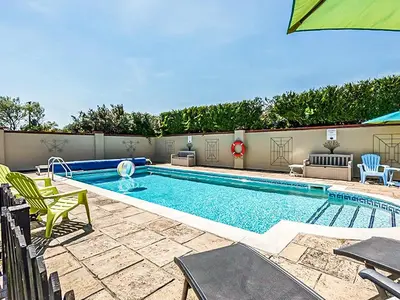 a large swimming pool with chairs at Swallow - Uk48172 in Colchester