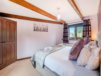a bedroom with a bed and a window at Swallow - Uk48172 in Colchester