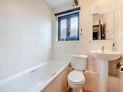 a white bathroom with a toilet and a sink at Swallow - Uk48172 in Colchester