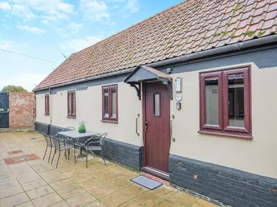 a house with a table and chairs and a red door at Swallow - Uk48172 in Colchester
