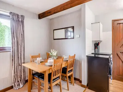 a kitchen and dining room with a table and a refrigerator at Swallow - Uk48172 in Colchester