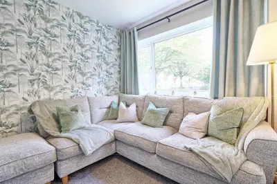 a living room with a couch and a window at Modern 5-Bed Property, Ideal for Extended Business & Contractor Stays in Colchester