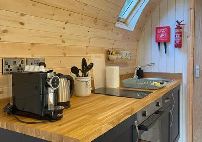 a kitchen with a counter top with a coffee maker at Great Hallingbury Lodges in Hallingbury