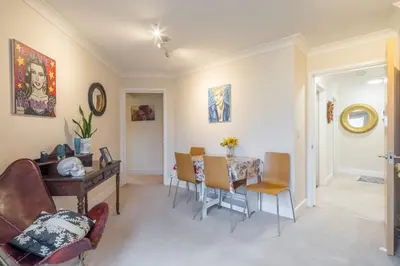 a living room with a dining room table and chairs at Fabulous Central 3Bed Apt - With Parking in Cambridge