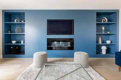 a living room with blue walls and a fireplace at Contemporary 3 Bedroom Fully Detached Town House in Wickford