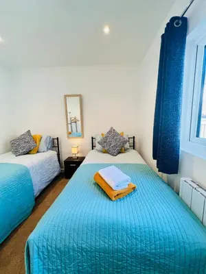 a bedroom with two beds and a window at Unique Apartment with Stunning Views 2B in Felixstowe