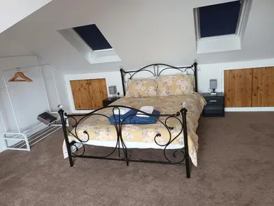 a bedroom with a bed in a room with windows at Unique Apartment with Stunning Views 2B in Felixstowe