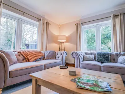 a living room with couches and a coffee table at Brook Lodge in Ipswich