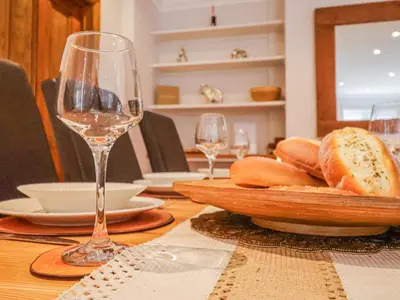 a table with a plate of bread and glasses of wine at Brook Lodge in Ipswich