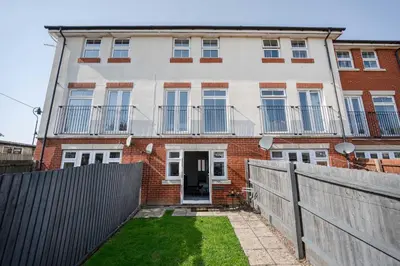 an apartment building with a fence in front of it at Caboose Stays - Bury St Edmunds - Modern 4 Bed townhouse close to centre and major transport links - Fast Wifi - Parking - Business and Contractors in Bury Saint Edmunds