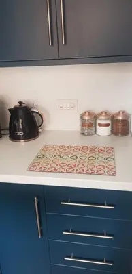 a kitchen counter with a tea kettle on a stove at Hythe House - Stylish Stay for Families & Groups by Catchpole Stays in Colchester