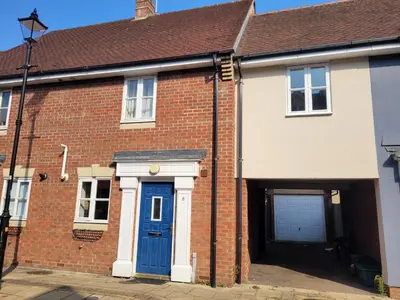 a brick house with a blue door at Hythe House - Stylish Stay for Families & Groups by Catchpole Stays in Colchester