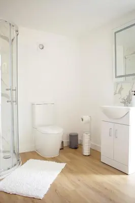 a bathroom with a toilet and a sink at Bespoke 1 Bedroom Barn by Stansted Airport & Holiday Parking in London Stansted Airport