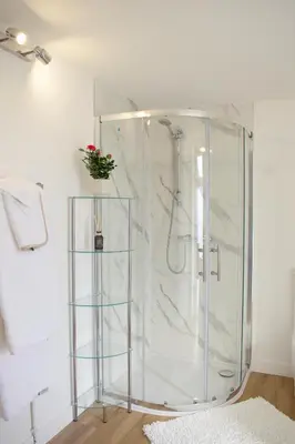 a bathroom with a shower with a glass enclosure at Bespoke 1 Bedroom Barn by Stansted Airport & Holiday Parking in London Stansted Airport