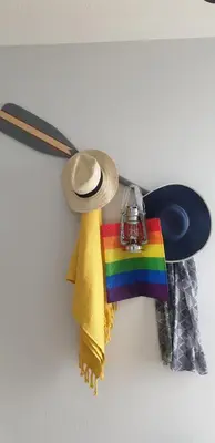 a hat and a rainbow flag and a hat and a scarf at Rainbow on Sea Frinton-on-Sea in Kirby Cross