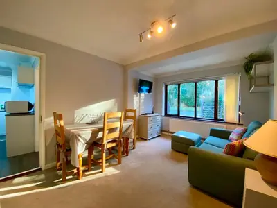 a kitchen and living room with a table and a couch at The Annex in Tostock