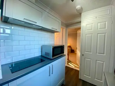 a kitchen with a microwave on top of a counter at The Annex in Tostock