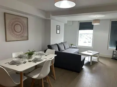 a living room with a table and a couch at 1 bed spacious flat in Essex in Brentwood