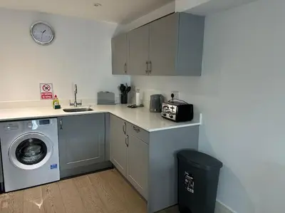 a kitchen with a sink and a washing machine at 1 bed spacious flat in Essex in Brentwood
