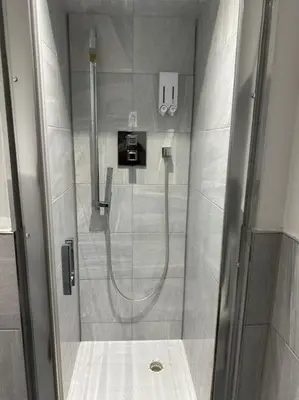 a shower with a glass door in a bathroom at 1 bed spacious flat in Essex in Brentwood