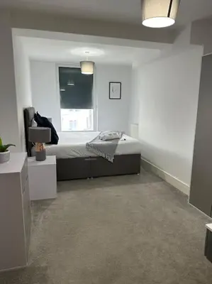 a white room with a bed and a window at 1 bed spacious flat in Essex in Brentwood
