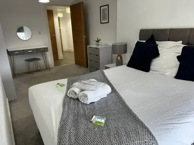 a bedroom with a bed with towels on it at 1 bed spacious flat in Essex in Brentwood