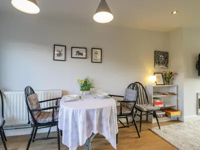 a dining room with a table and chairs at 25 Resbury Close in Cambridge