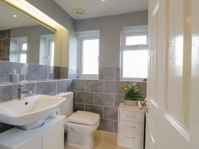 a bathroom with a sink toilet and a mirror at 25 Resbury Close in Cambridge