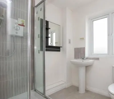 a bathroom with a glass shower and a sink at Colchester Retreat 4br 2bath Ample Street Parking in Colchester