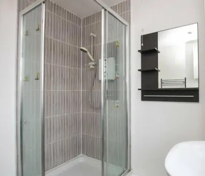 a shower with a glass door in a bathroom at Colchester Retreat 4br 2bath Ample Street Parking in Colchester
