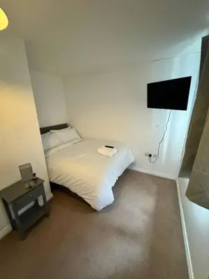 a small bedroom with a bed and a tv at Colchester Retreat 4br 2bath Ample Street Parking in Colchester