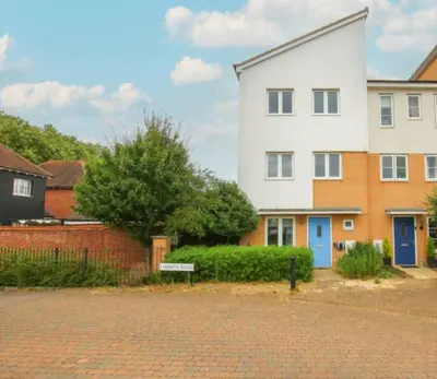a white house with a blue door on a street at Colchester Retreat 4br 2bath Ample Street Parking in Colchester