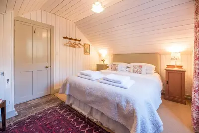 a bedroom with a bed with towels on it at The Stables, Hasketon in Debach