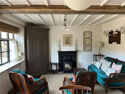 a living room with a couch and a fireplace at The Stables, Hasketon in Debach