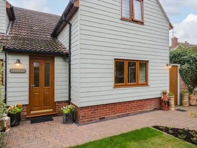 a white house with a brown door at Oakleaves in Colchester
