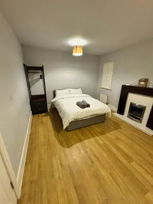 a bedroom with a bed and a fireplace at 4br 2bath Home In Colchester Perfect For Big Group in Mile End