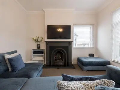 a living room with a couch and a fire place at Cosy Flat in Leigh Sea View - Pass the Keys in Southend-on-Sea