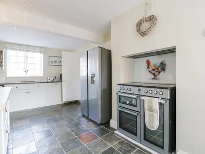 a kitchen with a stove and a refrigerator at Knights Farm in Ipswich