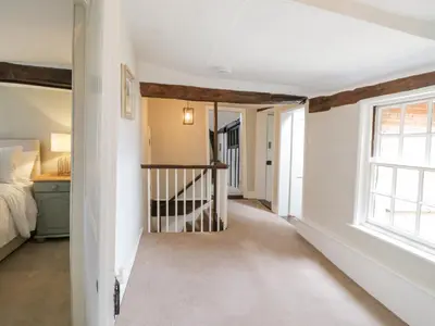 a hallway with a bed and a window at Knights Farm in Ipswich
