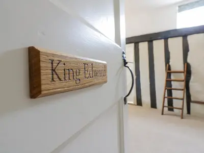 a wooden sign on the side of a wall at Knights Farm in Ipswich