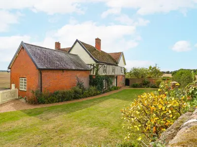 an old red brick house with a yard at Knights Farm in Ipswich