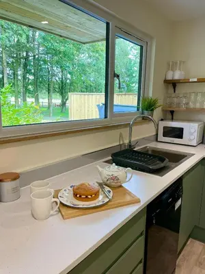 a kitchen with a plate of food on a counter at Copper Beech Lodge with Hot Tub, Games Room, Fire Pit in Toppesfield