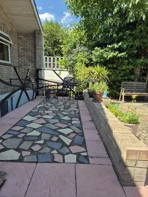 a patio with a bench and a mosaic floor at Secret Bunker at Vikings Forge in Bury Saint Edmunds